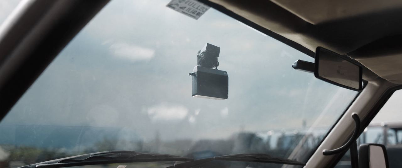 Forward-facing camera and sensor module mounted behind a car windshield